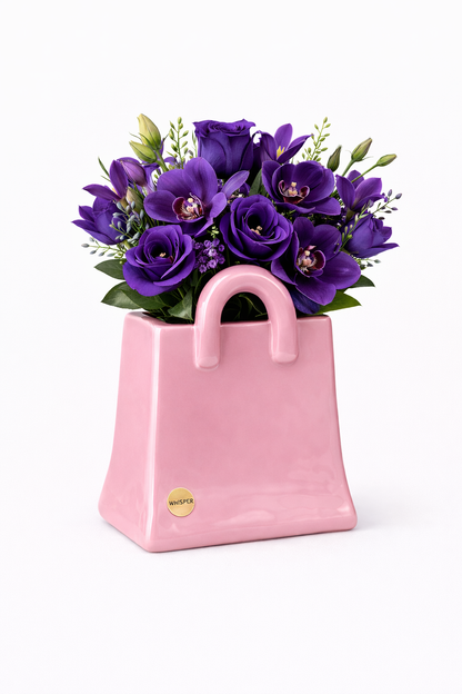 Pink ceramic bag with purple flowers on a white background