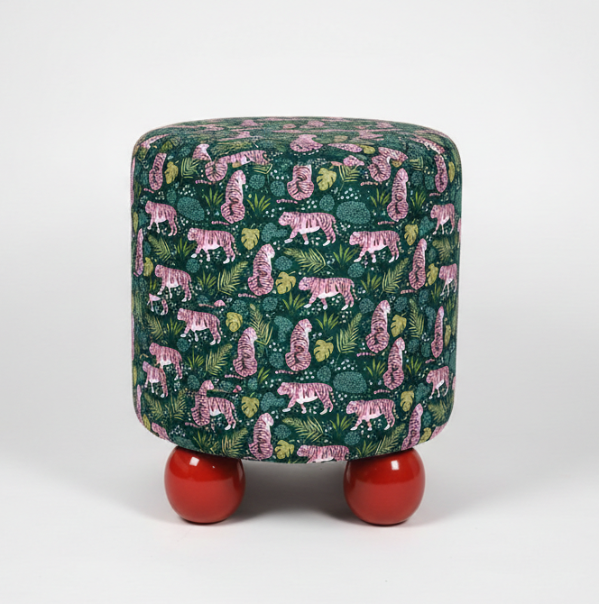 Pouf with tiger and leaf pattern on green fabric and red legs against a white background